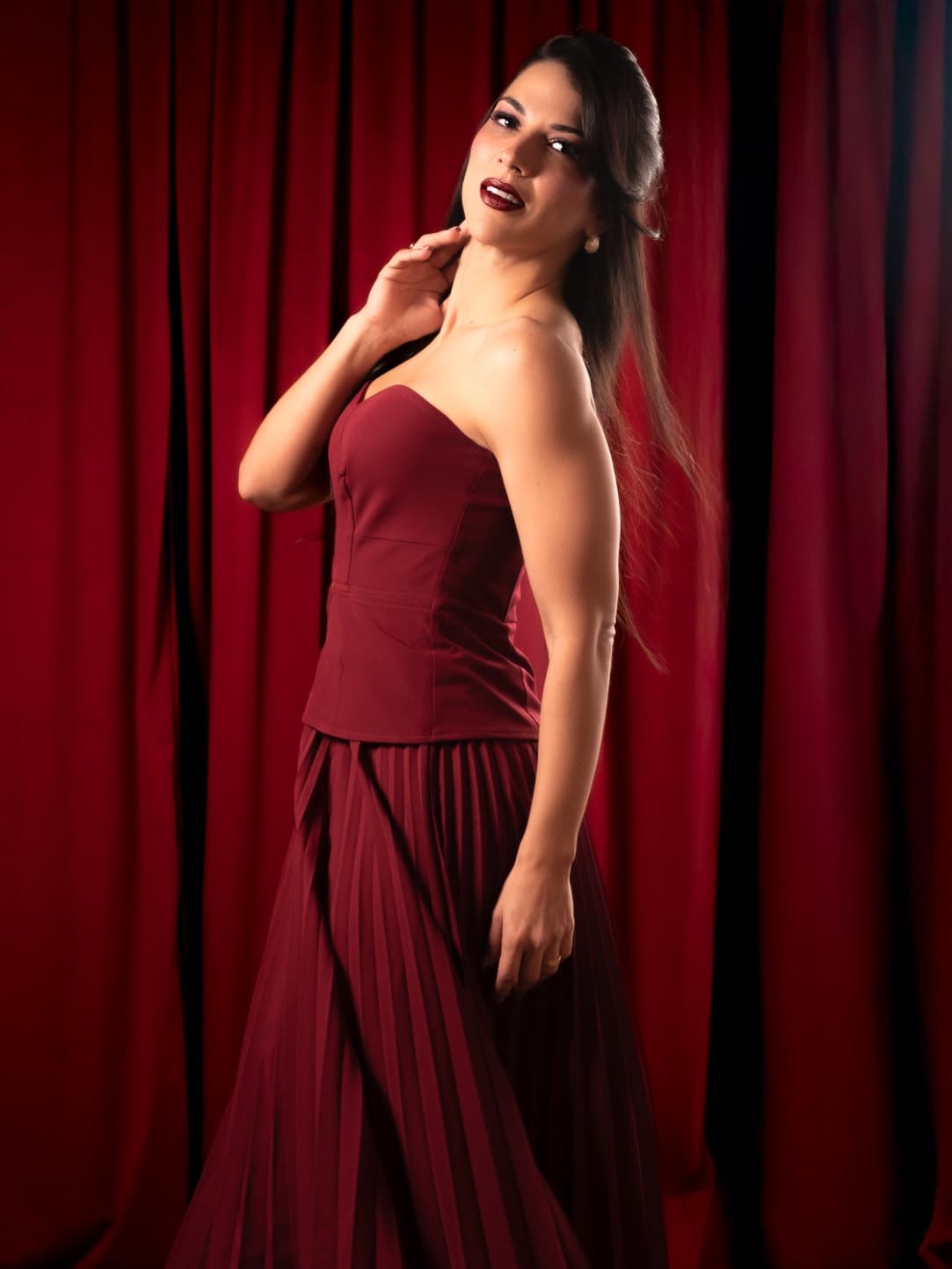 Ensaio boudoir sutil no Rio de Janeiro, mulher em conjunto vinho de cetim com pose elegante, Ensaio Fascínio Aura Estúdio